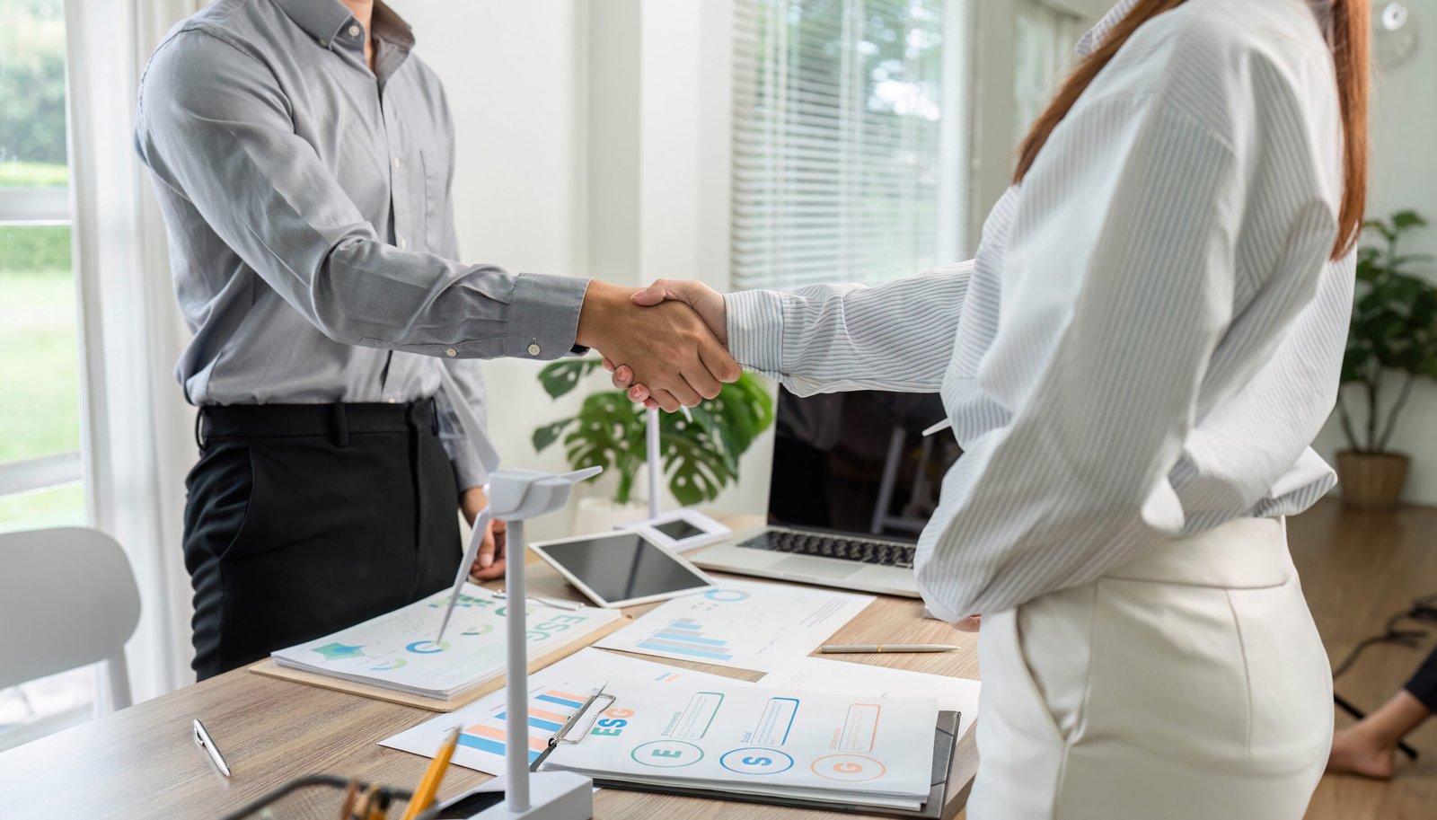 ESG Focused Handshake. Business professionals concluding a deal in an office.